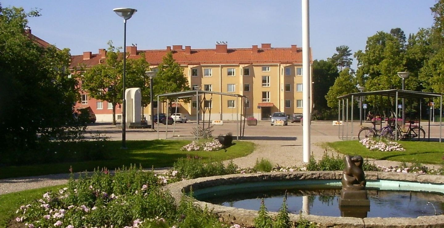 Fontän i stadskärna med hus i bakgrunden
